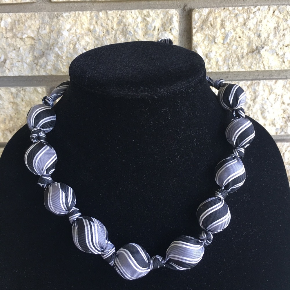 Tie necklace; black, white, and gray.